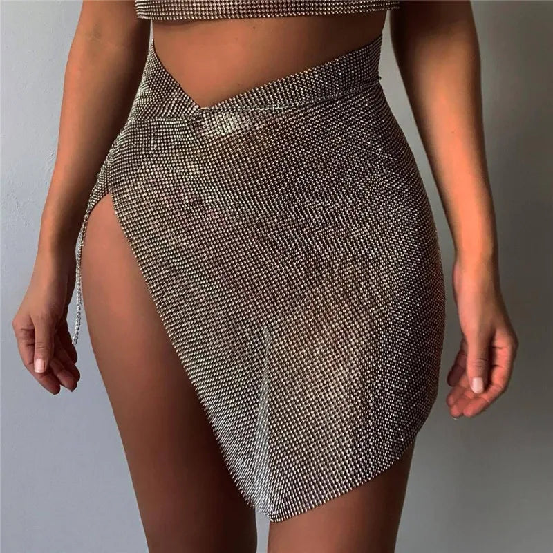 Mini saia com corrente de metal e strass brilhante para mulheres, saia sexy com fenda lateral transparente para festa, trajes para festival rave